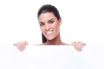 Cute woman presents with a blank white board