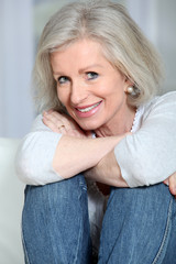 Closeup of smiling senior woman relaxing at home