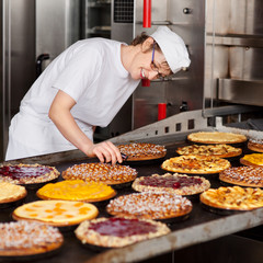 bäckerin prüft temperatur der kuchen