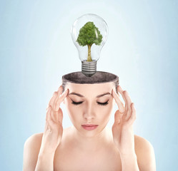 Open minded woman with green energy symbol