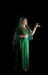 Fototapeta premium young girl in indian costume look at light