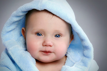 close-up portrait of a adorable baby in soft blue hod