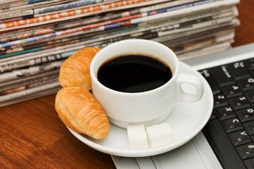 Cup from coffee and the newspaper