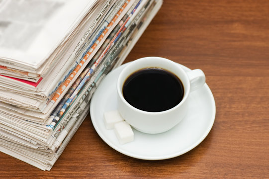 Cup from coffee and the newspaper