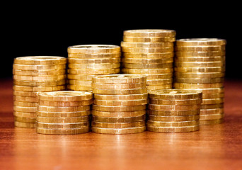 Golden coins on a wooden table