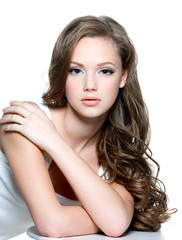teen girl with  long curly hairs and clean skin of the face