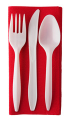 Plastic cutlery on red paper serviette - isolated