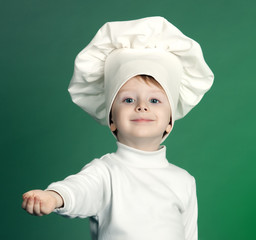 The cheerful little boy in a suit of the cook