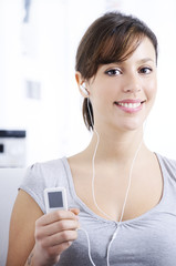 Naklejka premium young woman listening music in home interior.