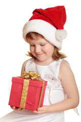 Baby girl in Santa's hat holding her Christmas present