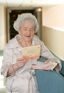 elderly woman opening mail