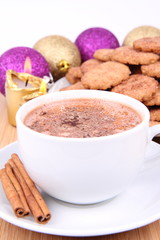 Cup of hot cocoa, cinnamon cookies and christmas decoration
