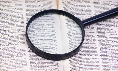 Magnifying Glass On Vintage Book.