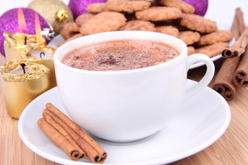 Cup of hot cocoa, cinnamon cookies and christmas decoration