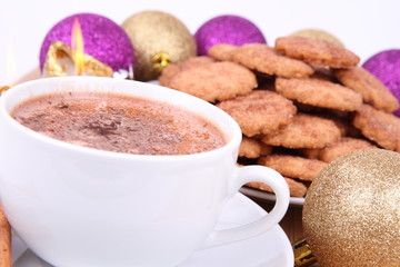 Cup of hot cocoa, cinnamon cookies and christmas decoration