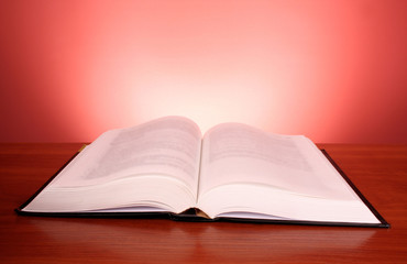 Big open book on red background