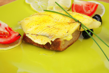 served roast golden fish fillet over wood