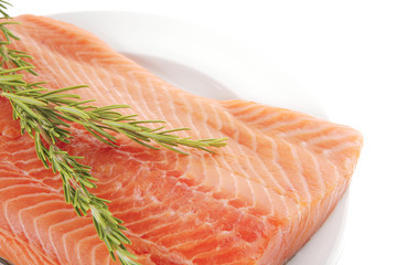 raw salmon fillet on white and rosemary