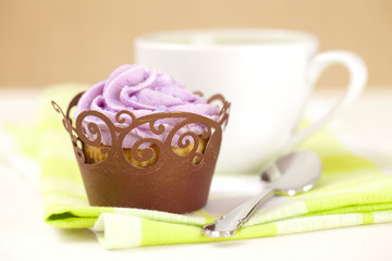 cupcake with lavender icing top in festive wrap and coffee cup