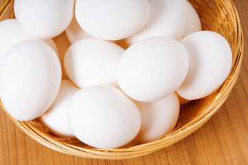 Many white eggs on the wooden table