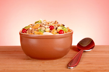 Muesli and spoon on red background