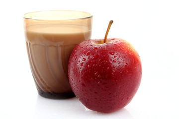 Glass with milk and apple isolated on white