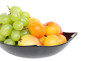 Grape, pear and apricot kept in bowl at shallow DOF