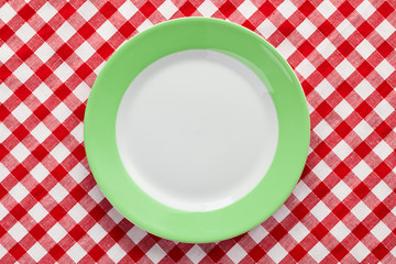 green plate on checkered tablecloth