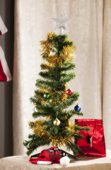 Christmas tree with parephernalia of Xmas around it