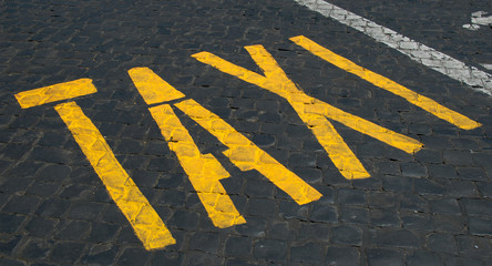 Taxi sign on cobblestones