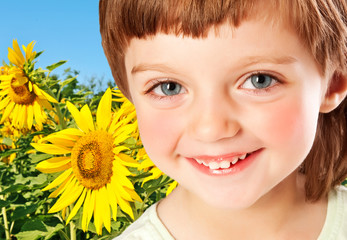 little girl and field with sunflowers