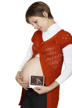 A pregnant woman is holding her stomach