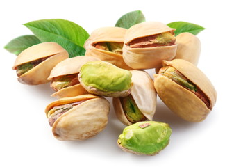 Pistachios with leaves on white background