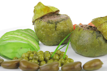 round zucchini filled mince meat served with tomatoes and peas