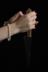 Female hands holding a knife