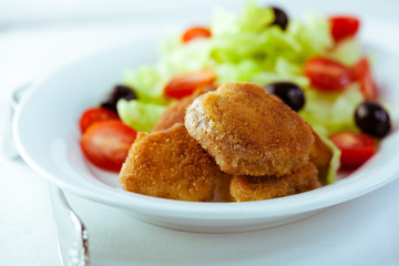 Chicken nuggets with salad