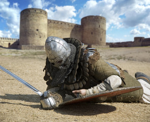 Medieval warrior defeated lying inside the fortress