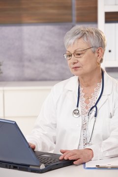 Senior doctor using laptop
