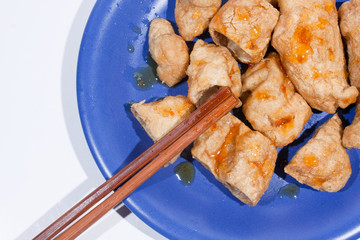 Fried fish balls with chopsticks.