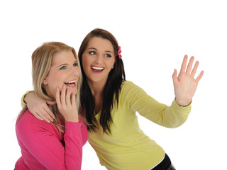 Two pretty girl friends having fun and laughing. isolated on whi