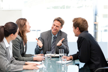 Happy team laughing together at a meeting