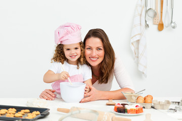 Portrait of an adorable mother and daughter preparing a daugh to