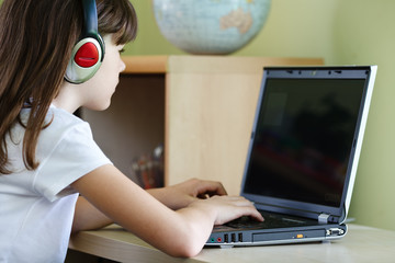 Girl using computer at home