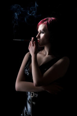 Obraz premium beautiful woman smokes a cigarette with a mouthpiece