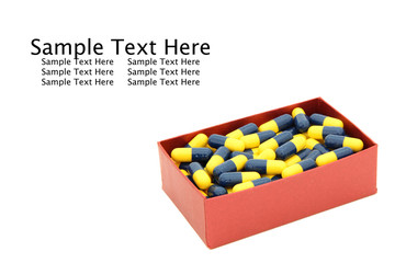 yellow blue capsules in red box