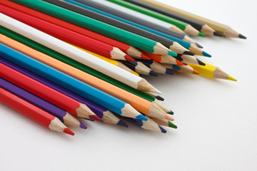 A number of colored pencils on white background