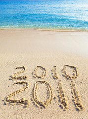 On sand at ocean edge it is written 