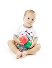 Cute little boy is playing with colorful balls
