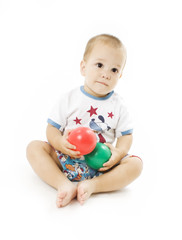 Fototapeta na wymiar Cute little boy is playing with colorful balls