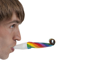 Man playing with party blowers